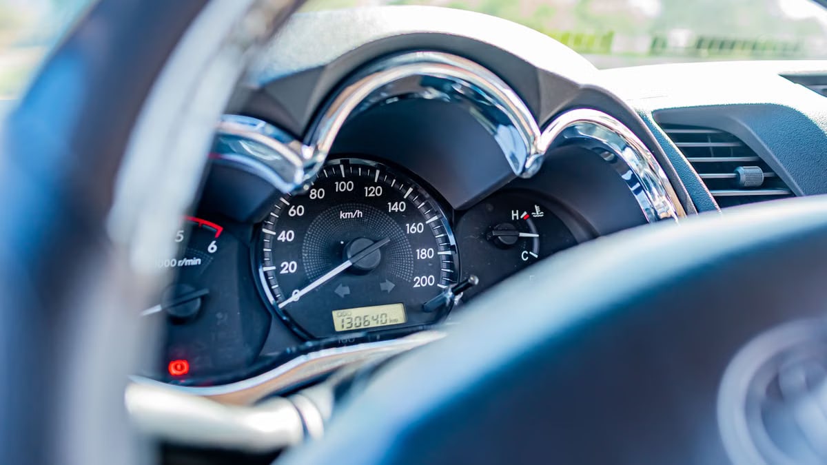 Detailed view of a car's speedometer and gauges from the driver's seat, highlighting instrument clarity.